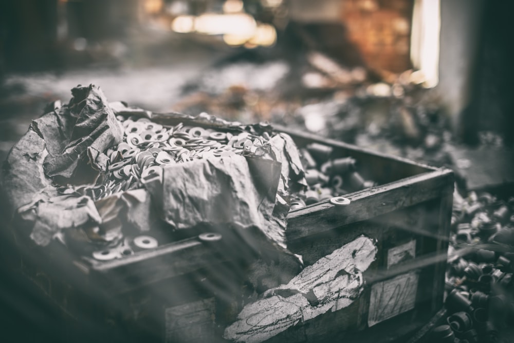 a box filled with lots of trash sitting on top of a pile of rubble