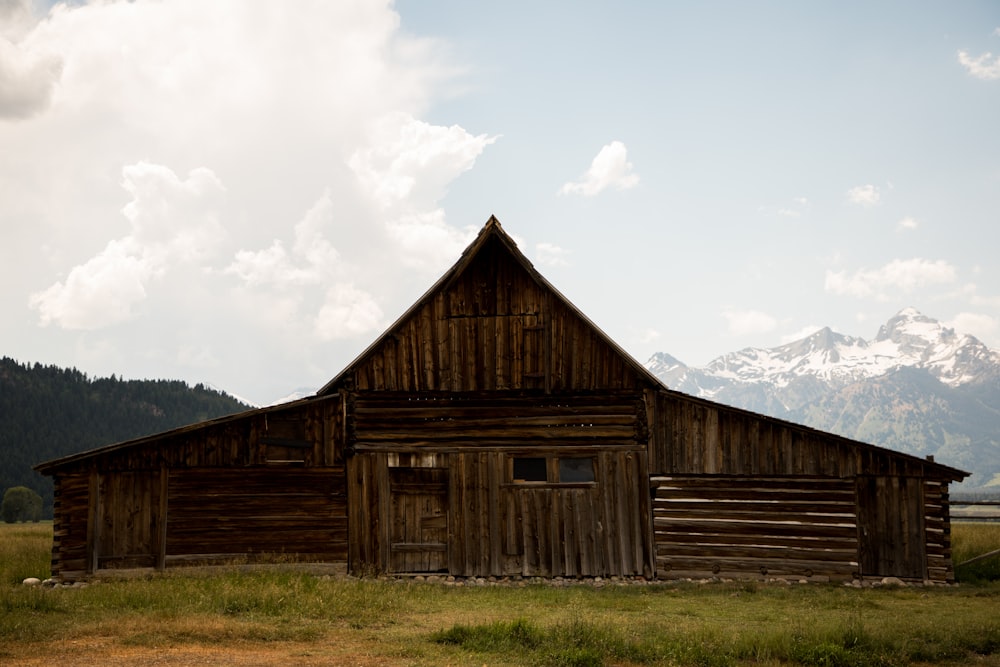 brown wooden barn on field