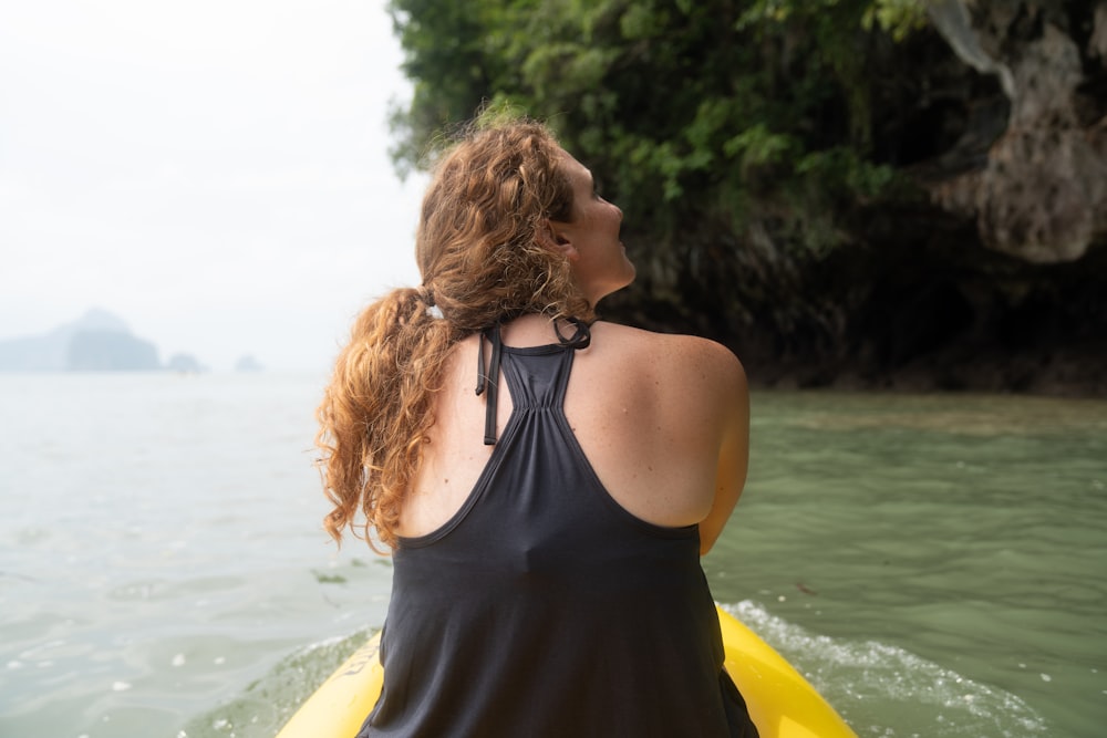 woman riding yellow kayak