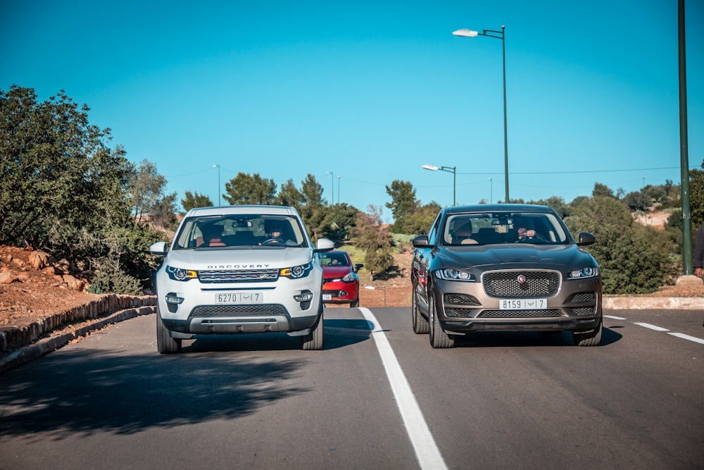 three vehicle in road during daytime