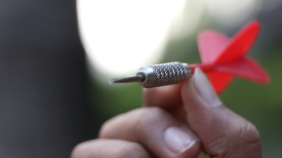 Close-up of a hand aiming a clay pigeon thrower with focus on technique
