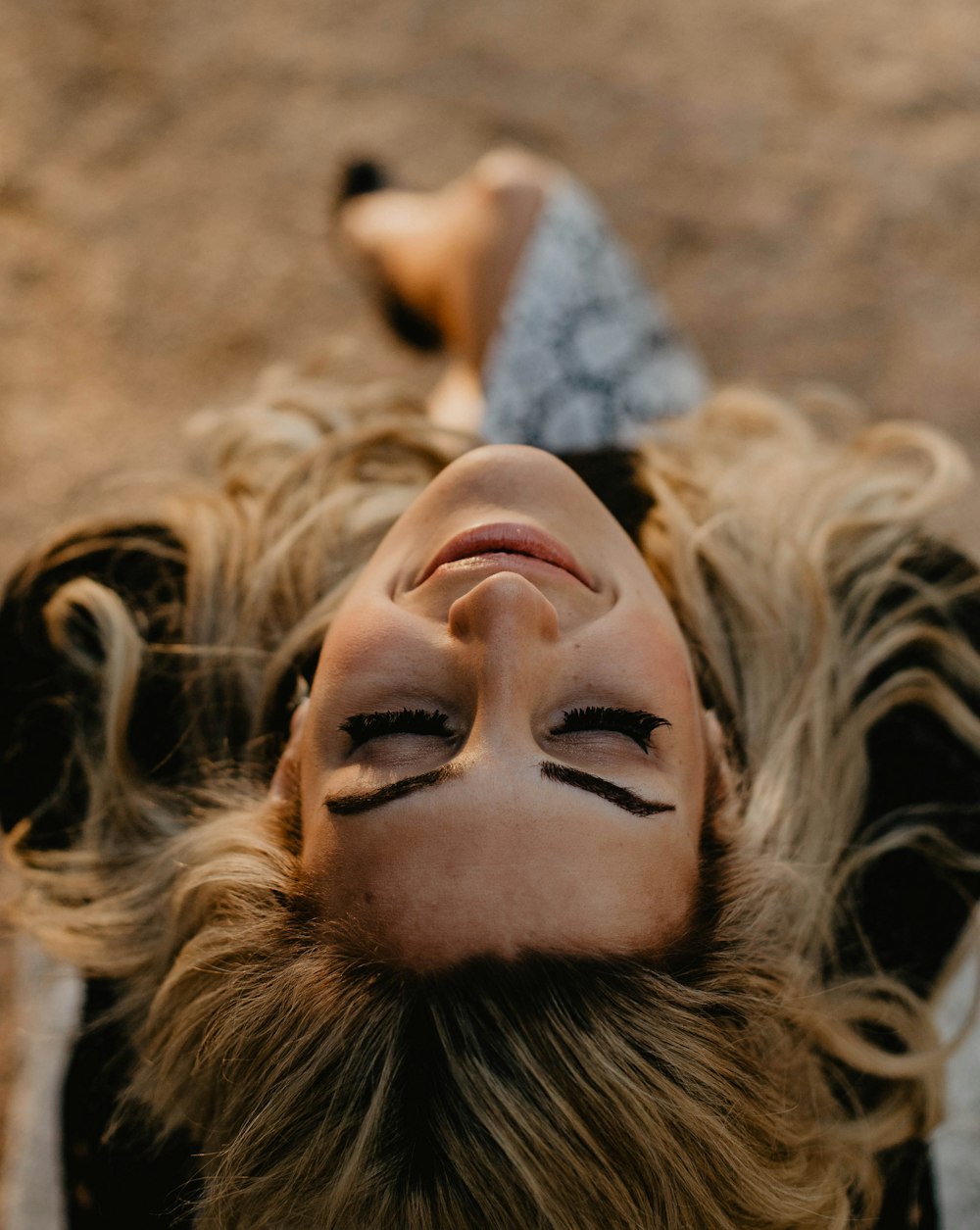 smiling woman looking up in selective focus photography