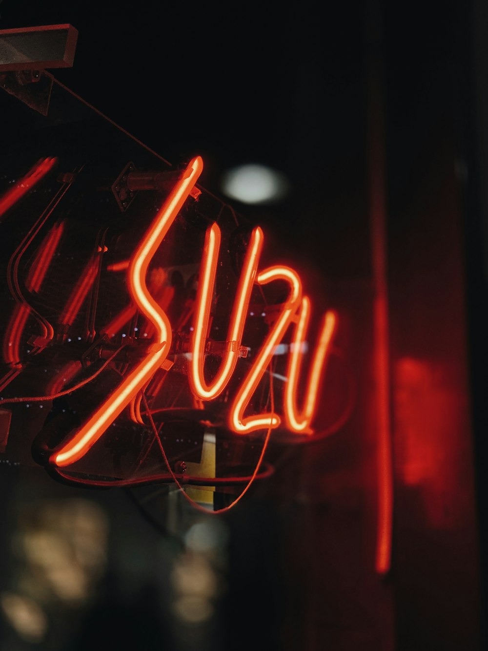 red Suzu neon light signage turned-on