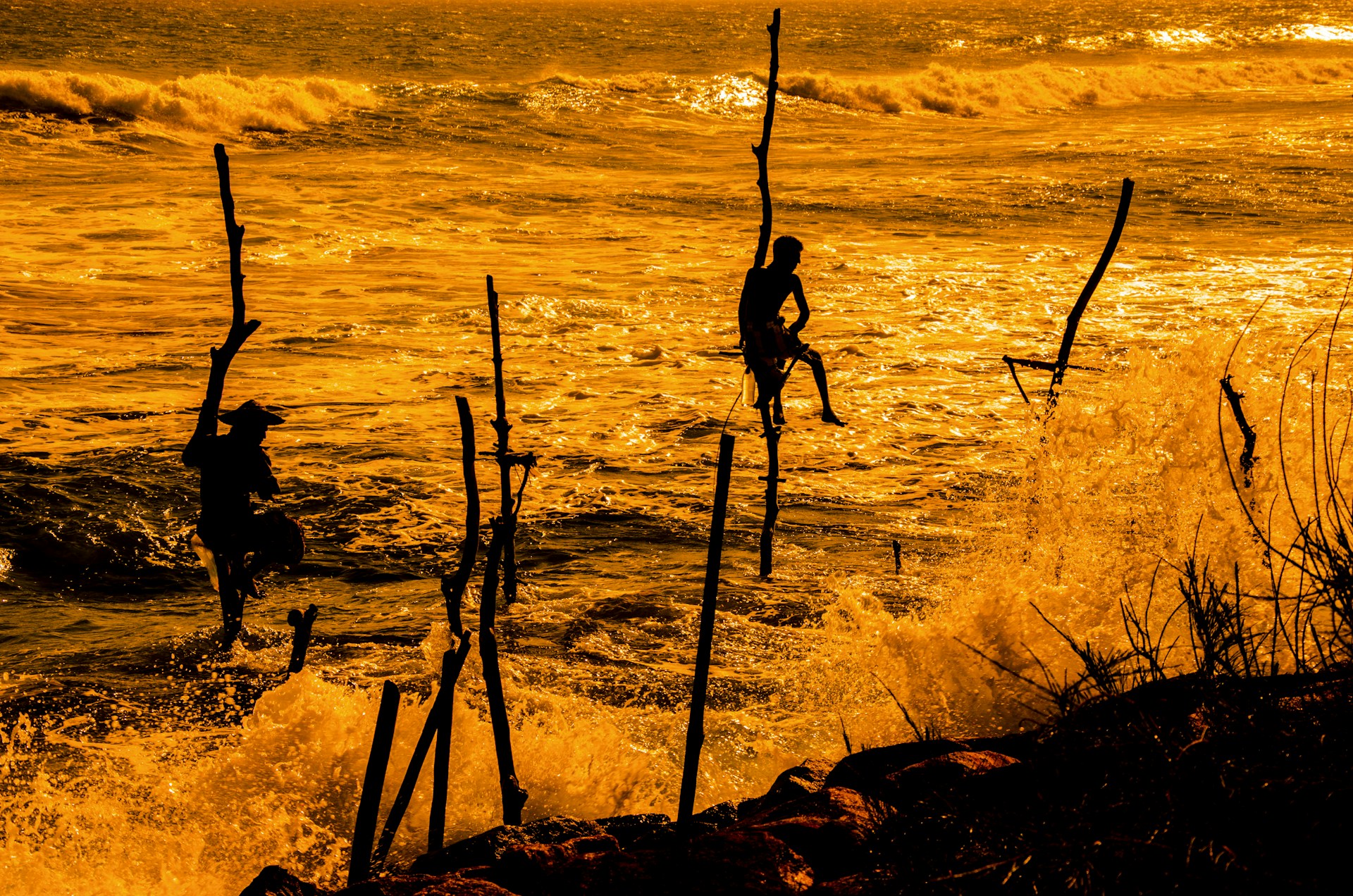 silhouette of two person near body of water