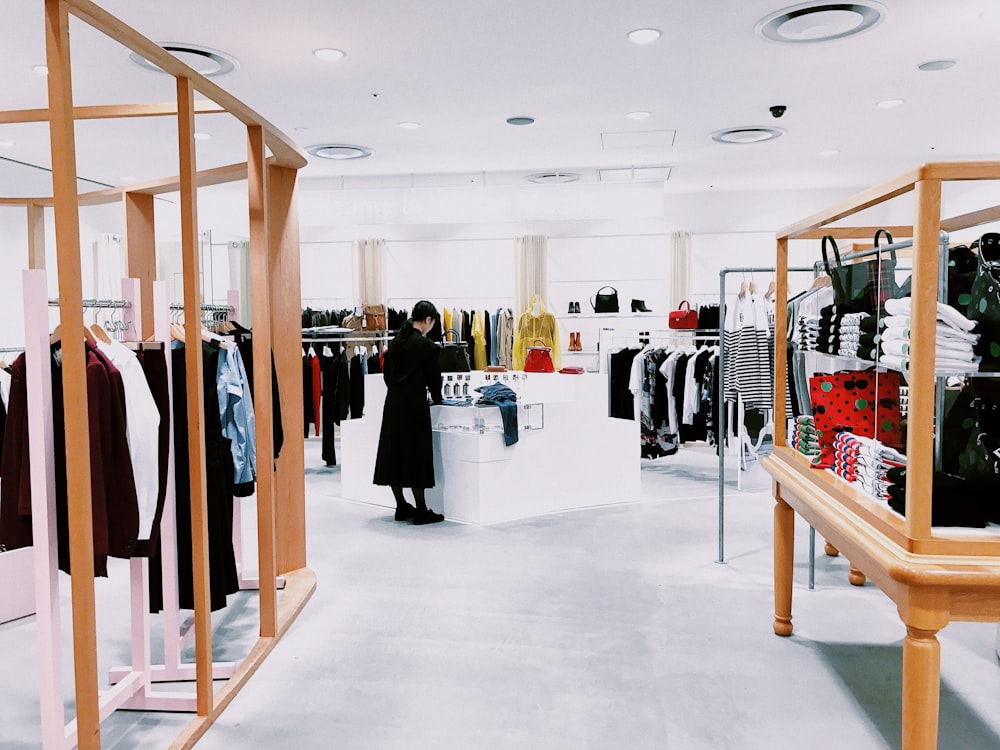 woman standing inside clothing area - customer loyalty program