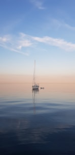 white sailboat at middle of sea