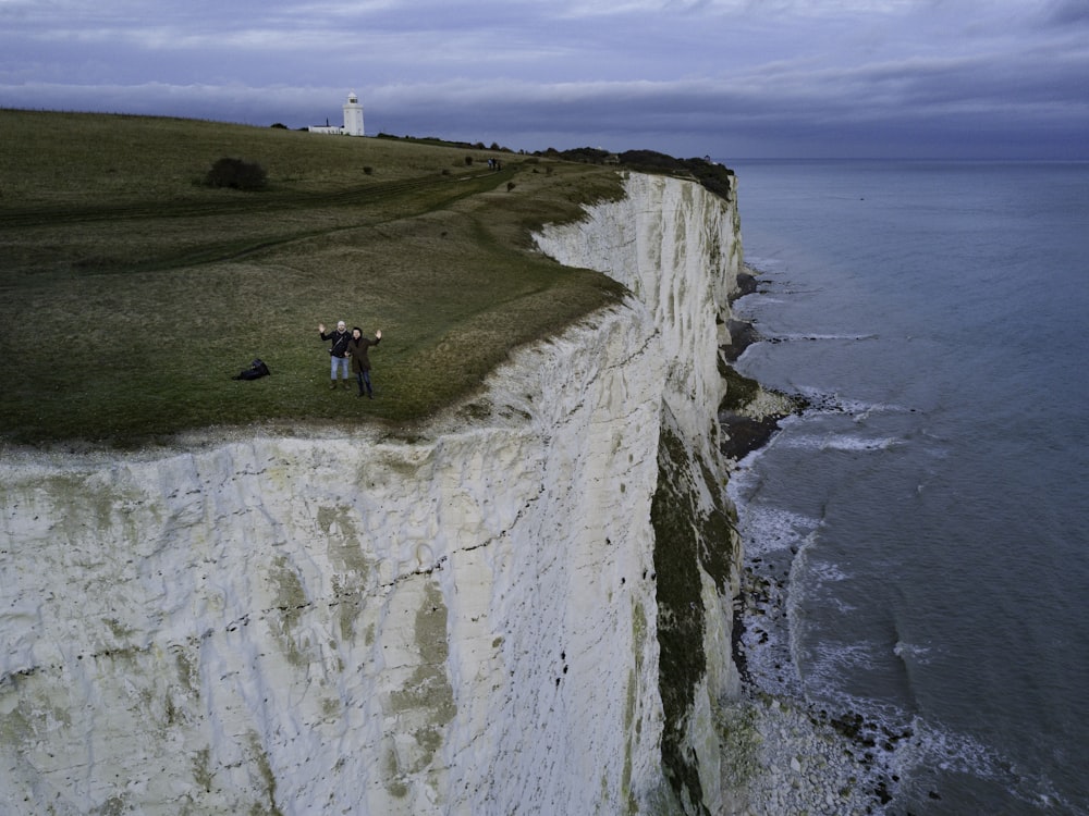 two people standing on hill