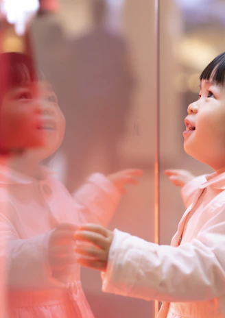 girl touching glass panel