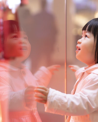 girl touching glass panel