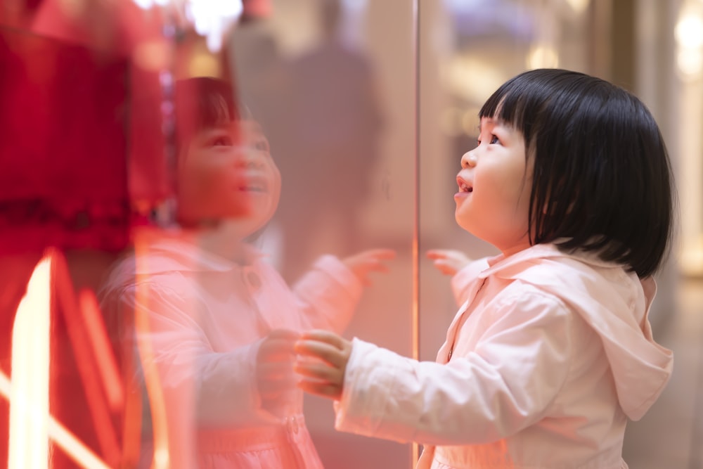 girl touching glass panel