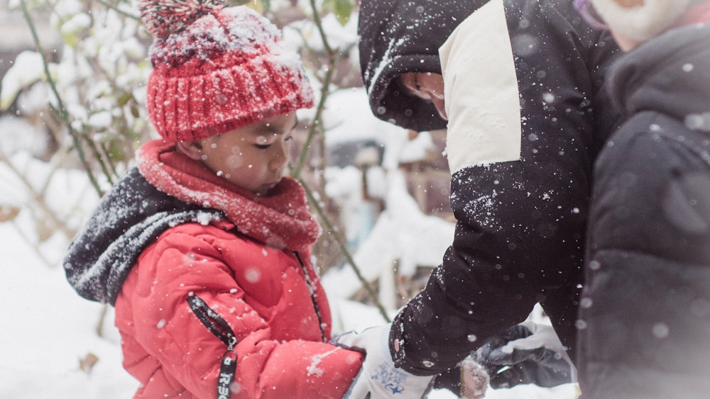 toddler standing on white snow