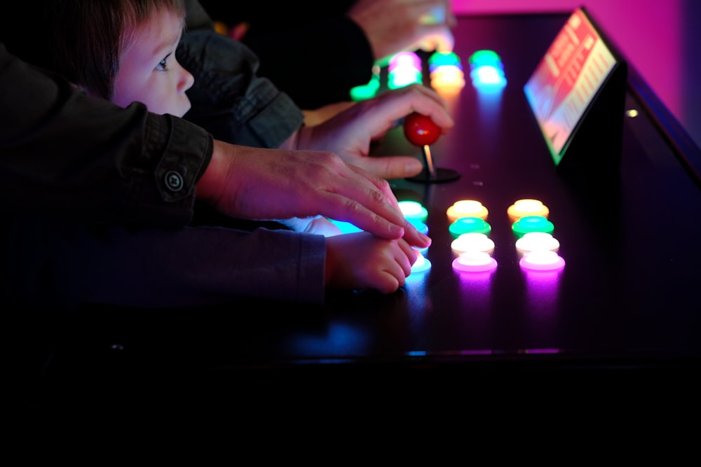 boy playing arcade cabinet