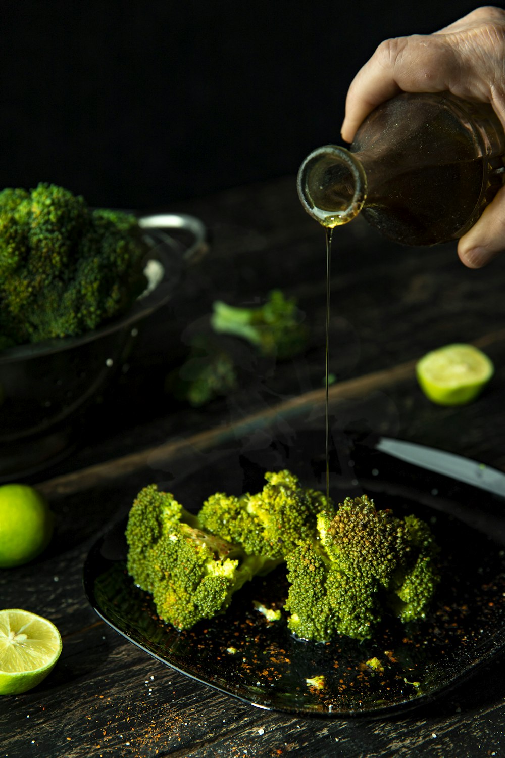 person pouring cola on broccoli