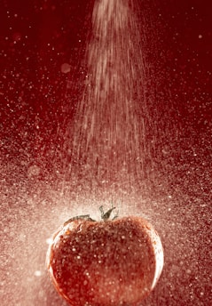 A vibrant splash of ripe tomatoes bursting against a rustic wooden background, symbolizing fresh and lively news.