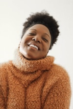 Close-up photo of a cozy sweater with a bold uplifting quote printed on the chest.