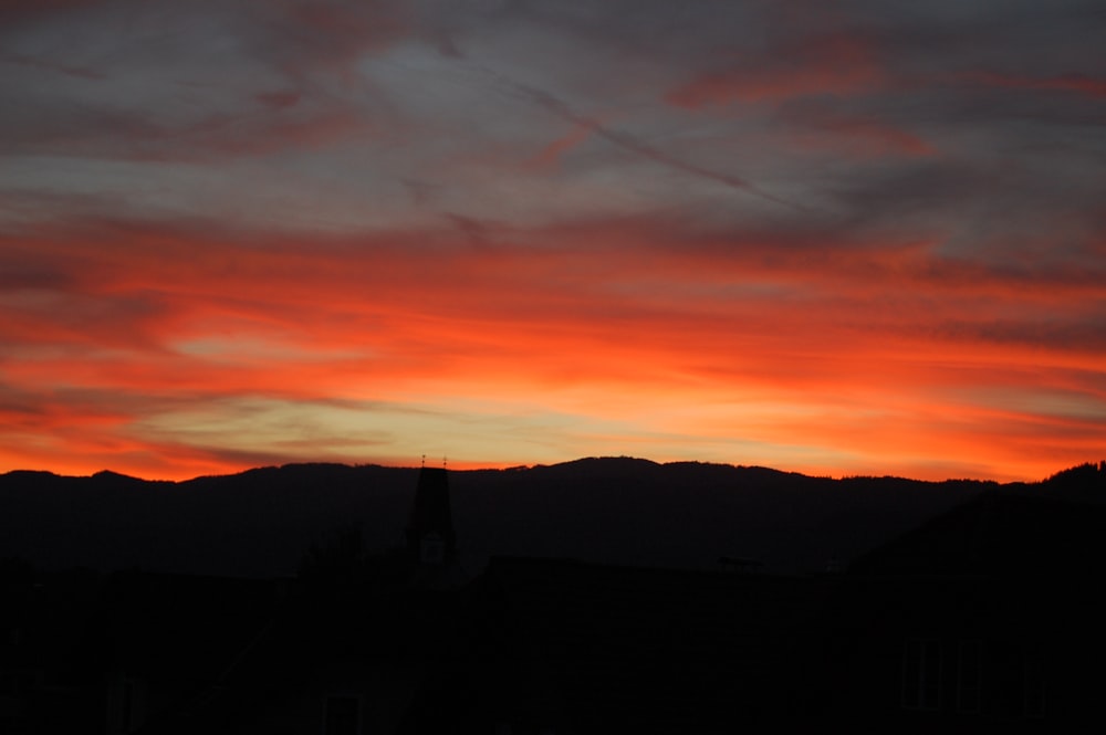 silhouette of mountain under orange sky