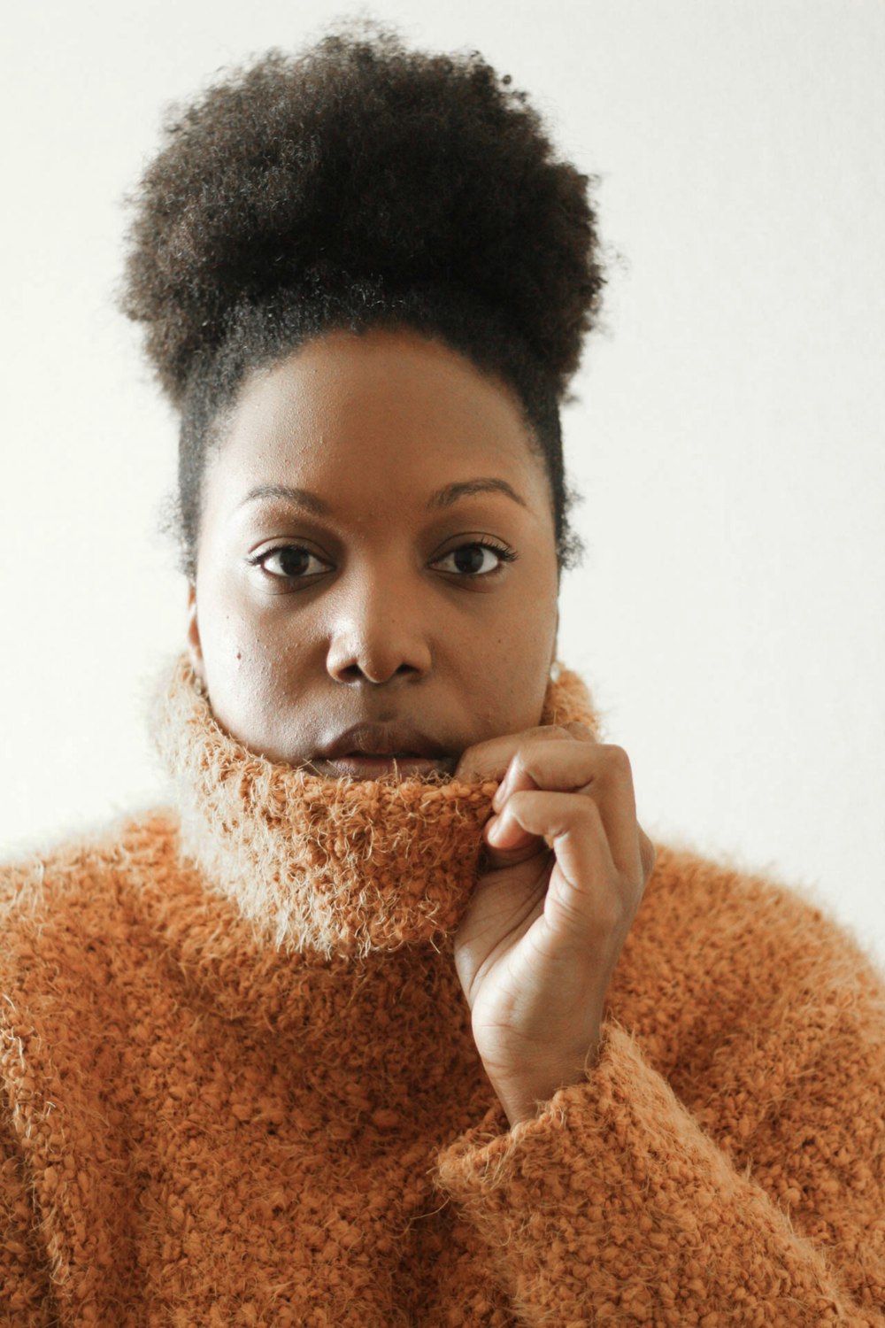 woman wearing brown turtleneck sweatshirt