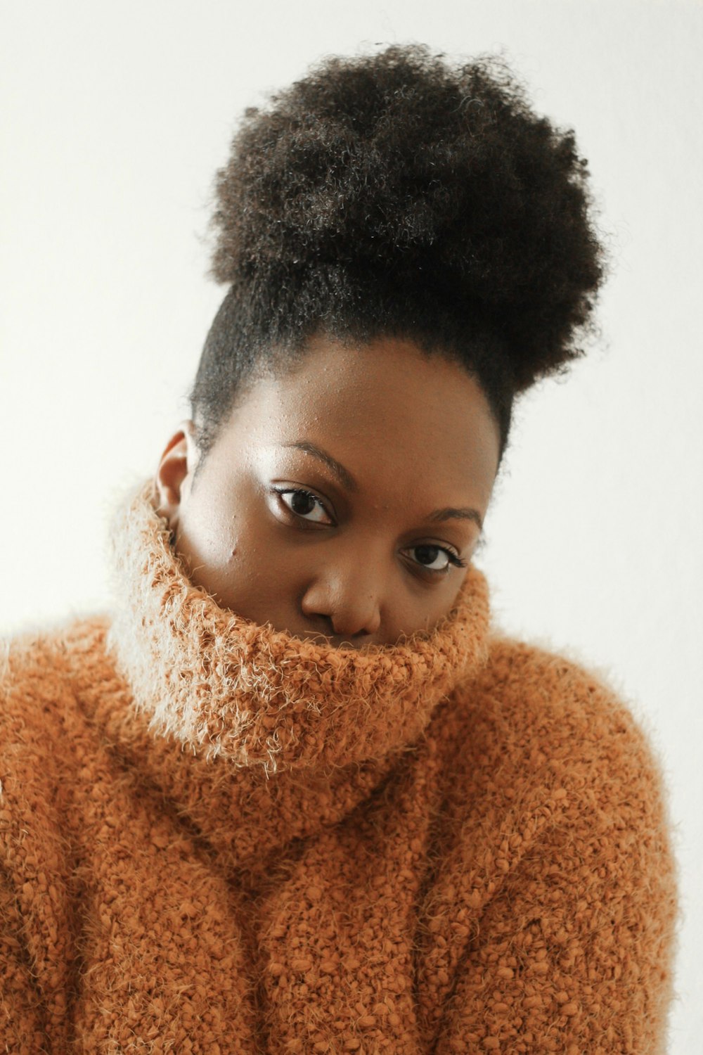 woman wearing brown turtleneck sweater