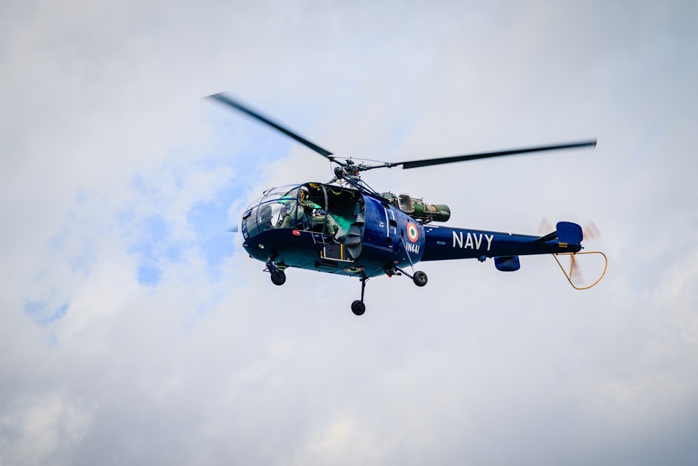 black Navy Huey helicopter flying