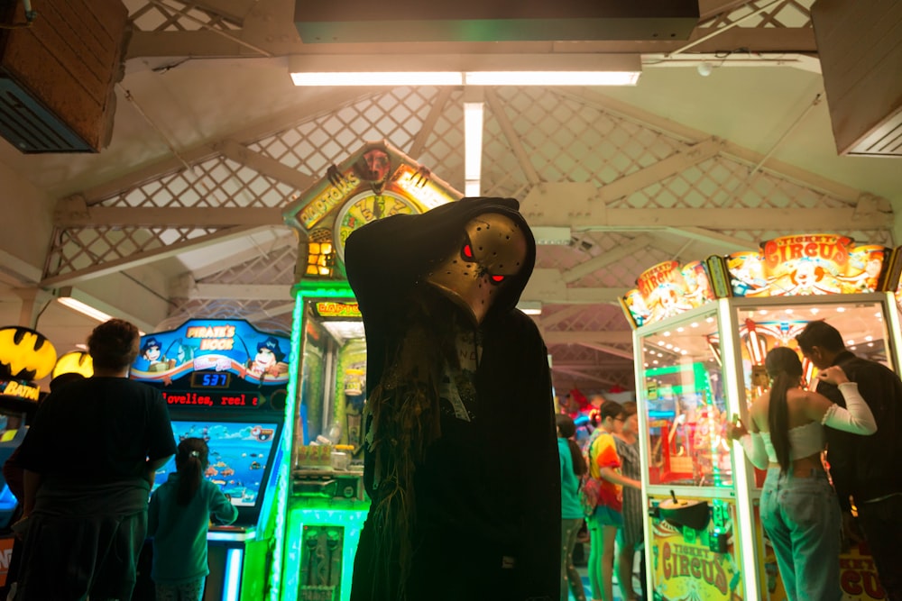 person standing near arcade machine