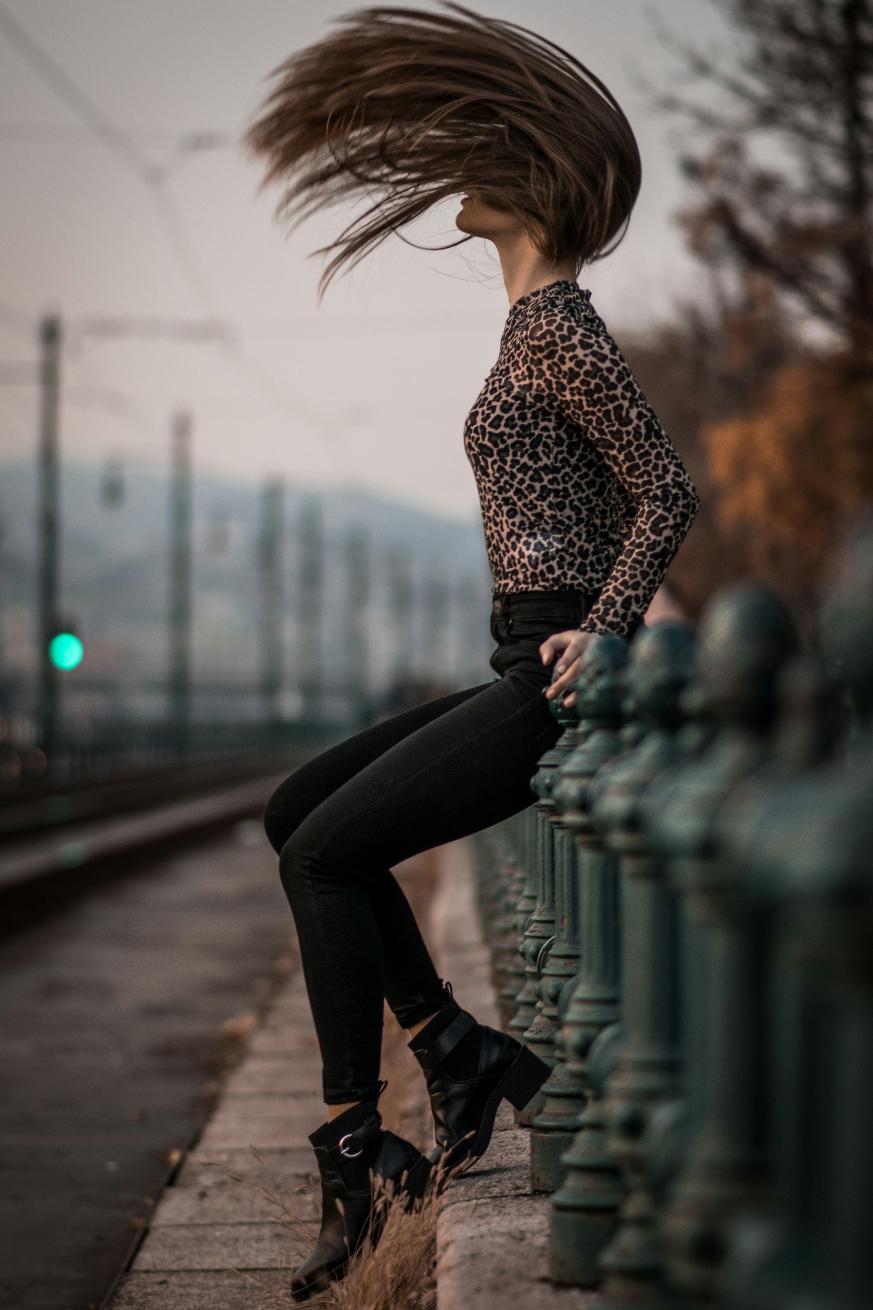 woman sitting while flipping hair during daytime