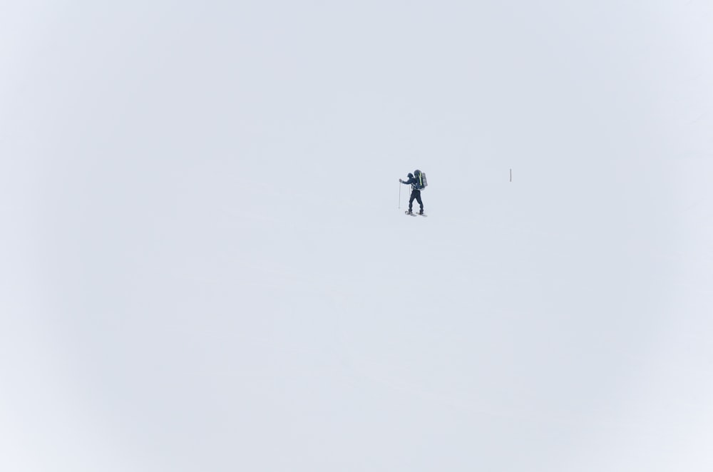 a person standing on a snowboard in the snow