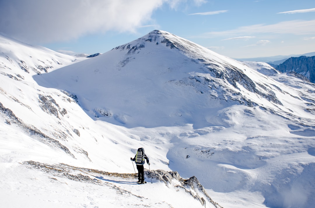 man climbing mountain