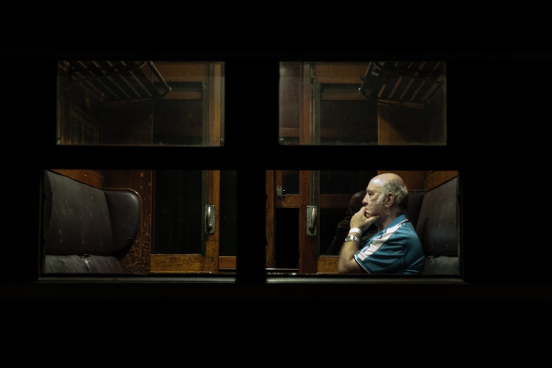 man sitting on chair, Man on a Train