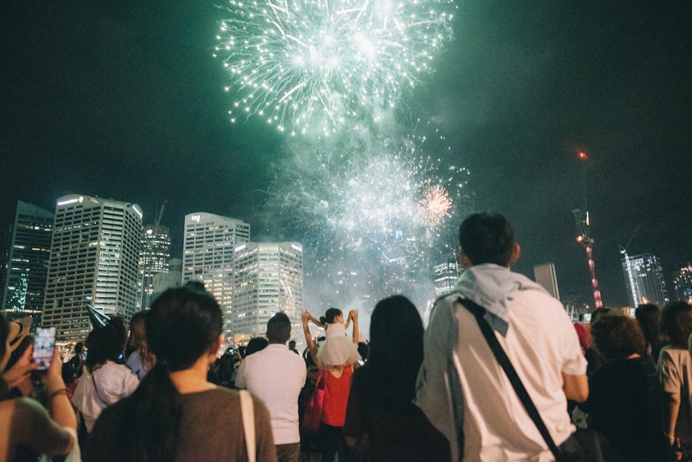 people standing near fireworks display