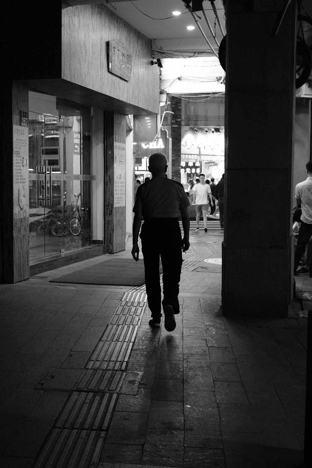 grayscale photo of a person walking