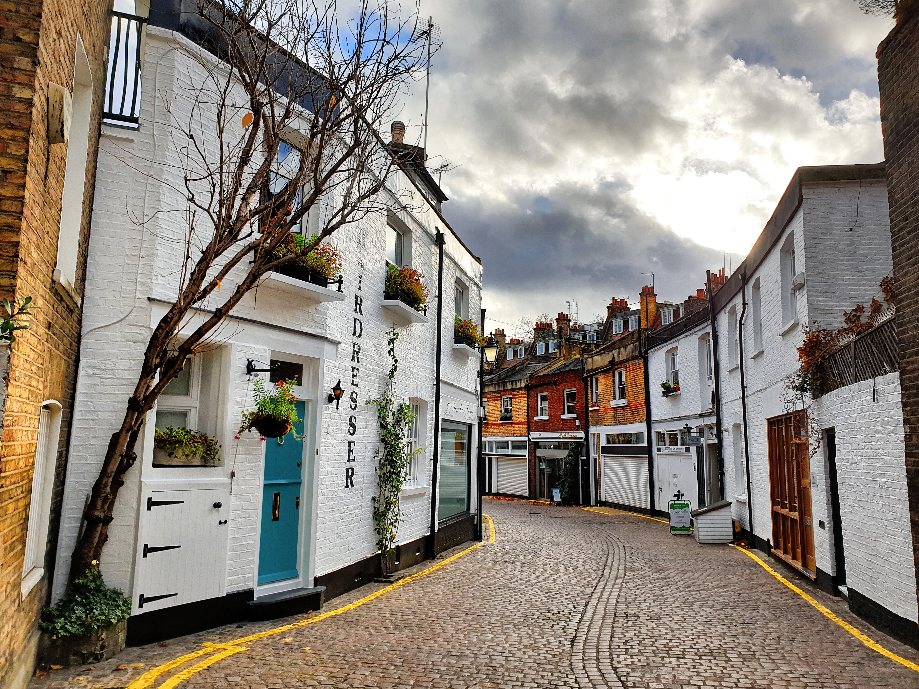 White-painted houses on a cobbled Kensington lane