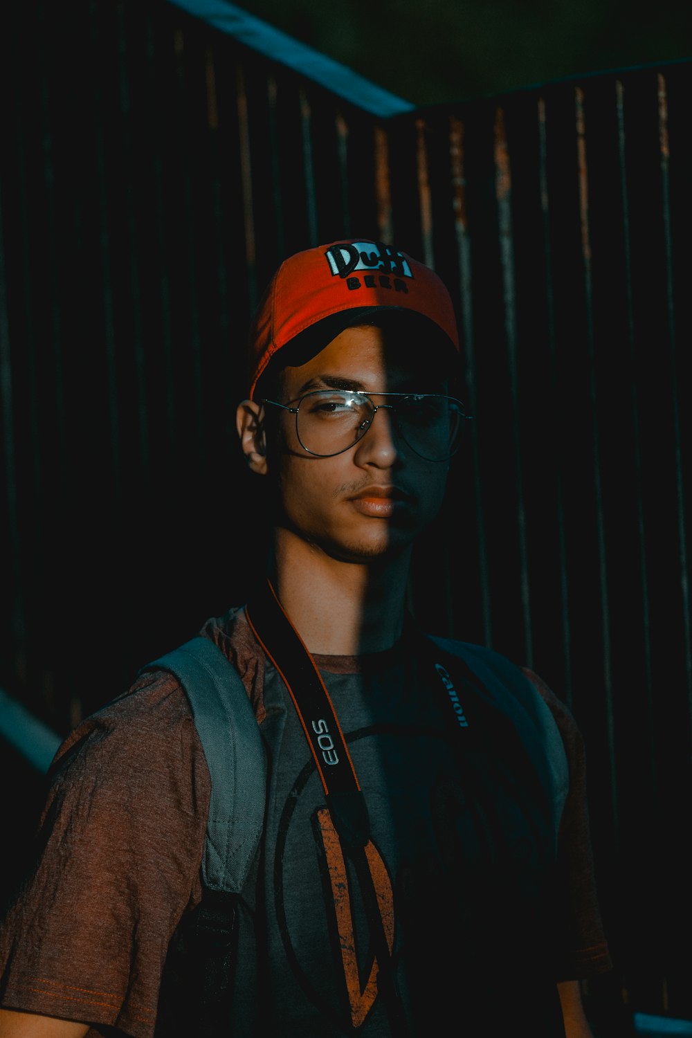 man with Canon EOS camera on his neck