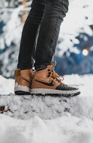 Warm winter boots set against a snowy background.