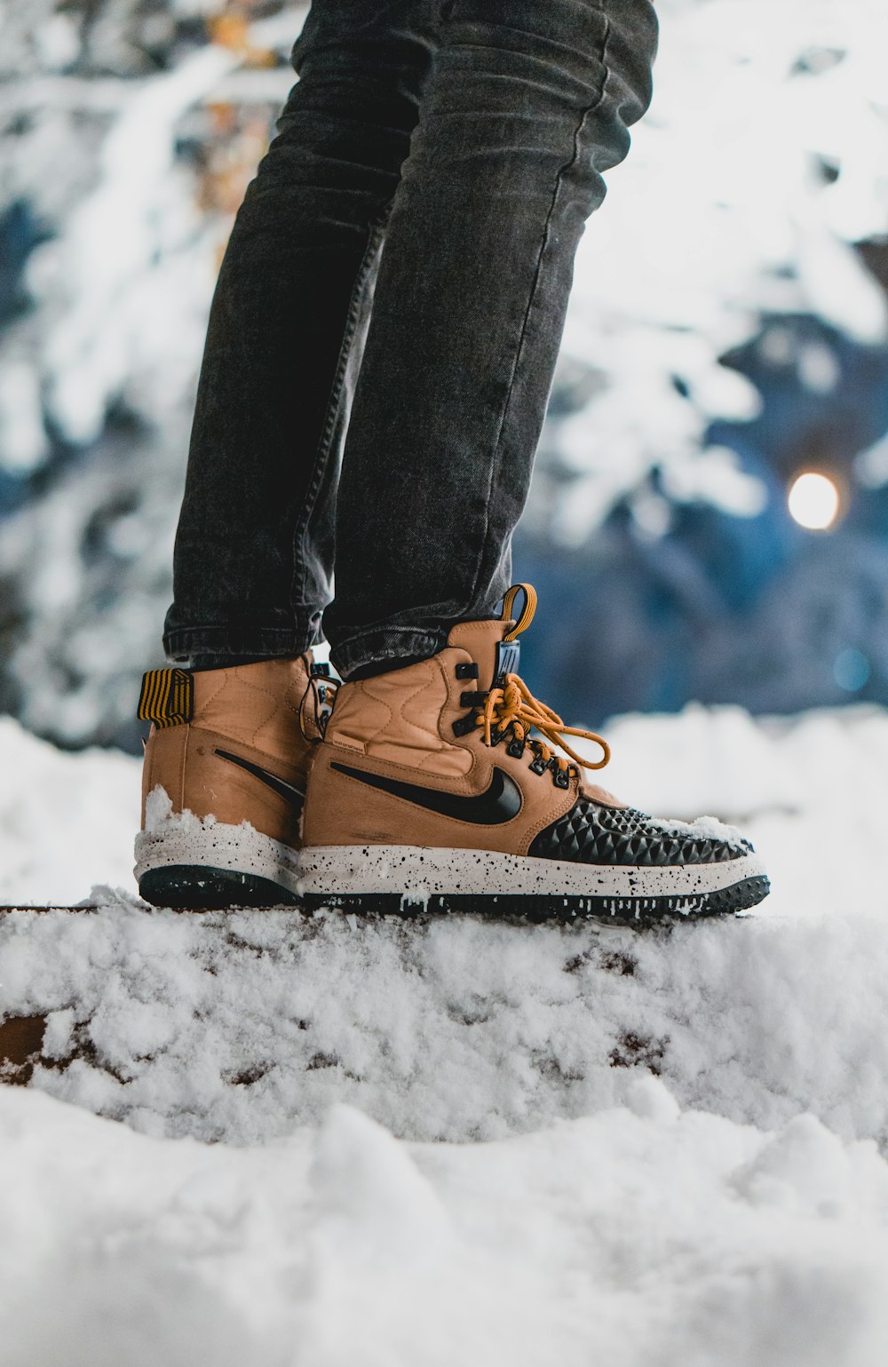 person wearing brown-and-black Nike leather sneakers