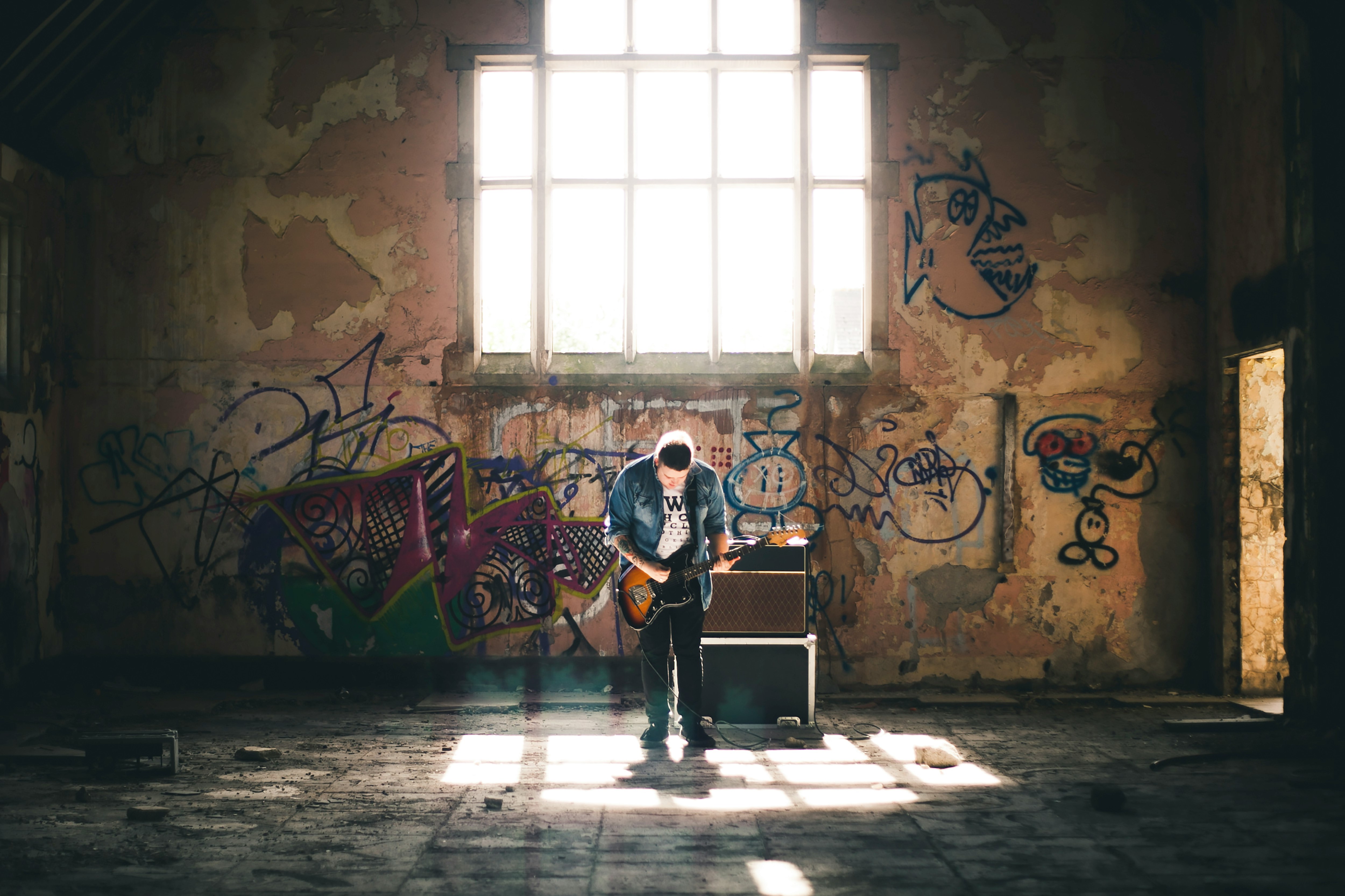 man playing guitar inside building