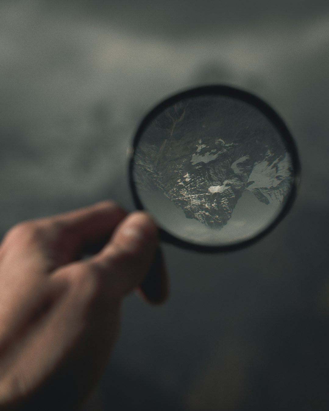 person holding magnifying glass