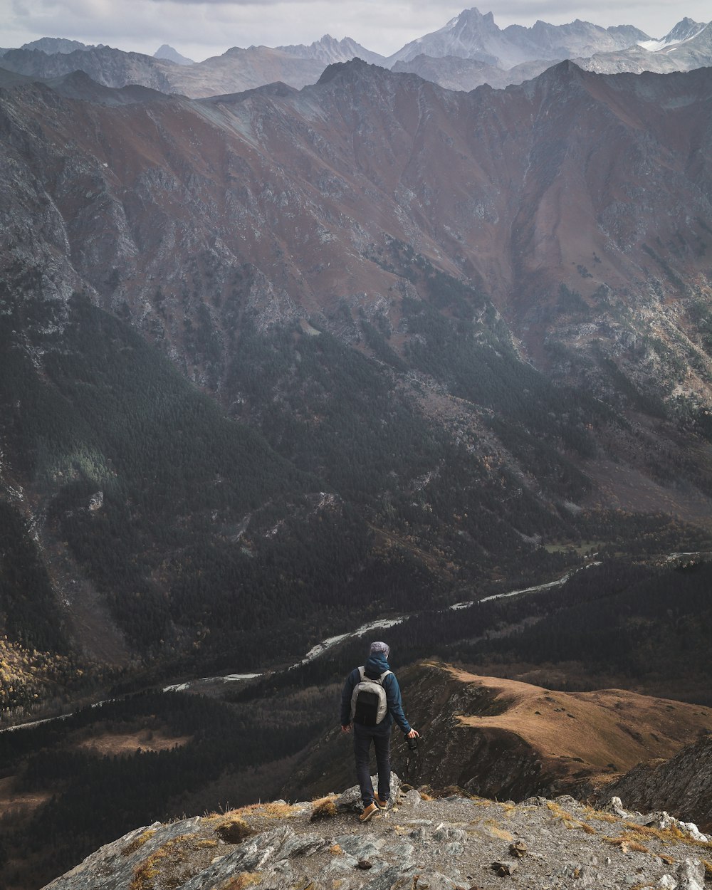 person standing near cliff during daytime