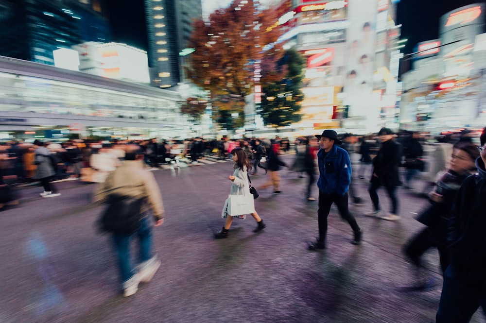 people walking in city at night