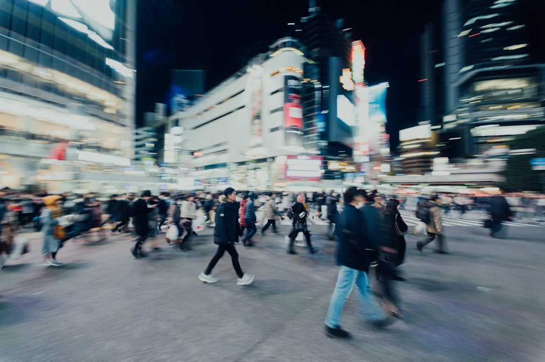 people walking on street near buildings during nighttime