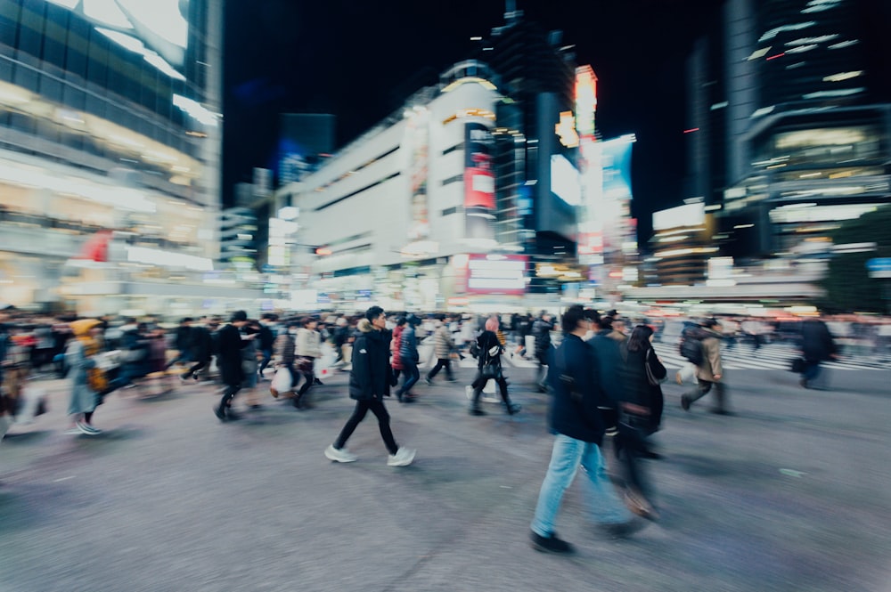 people walking on street near buildings during nighttime