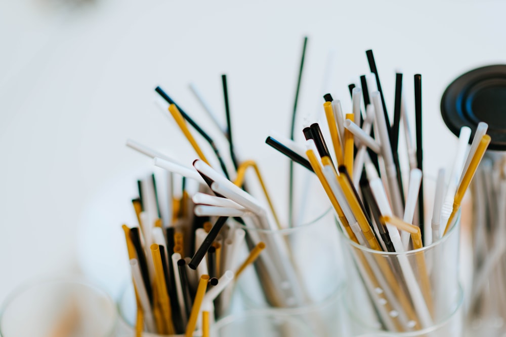 selective focus photography of zipping straws in clear plastic racks