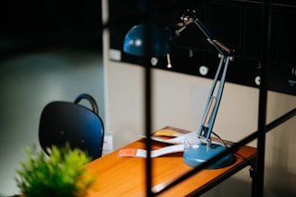 blue desk lamp on brown wooden desk