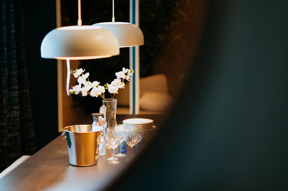 stainless steel bucket beside wine glasses