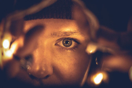Close-up of lighting instruments casting soft glows on actors.