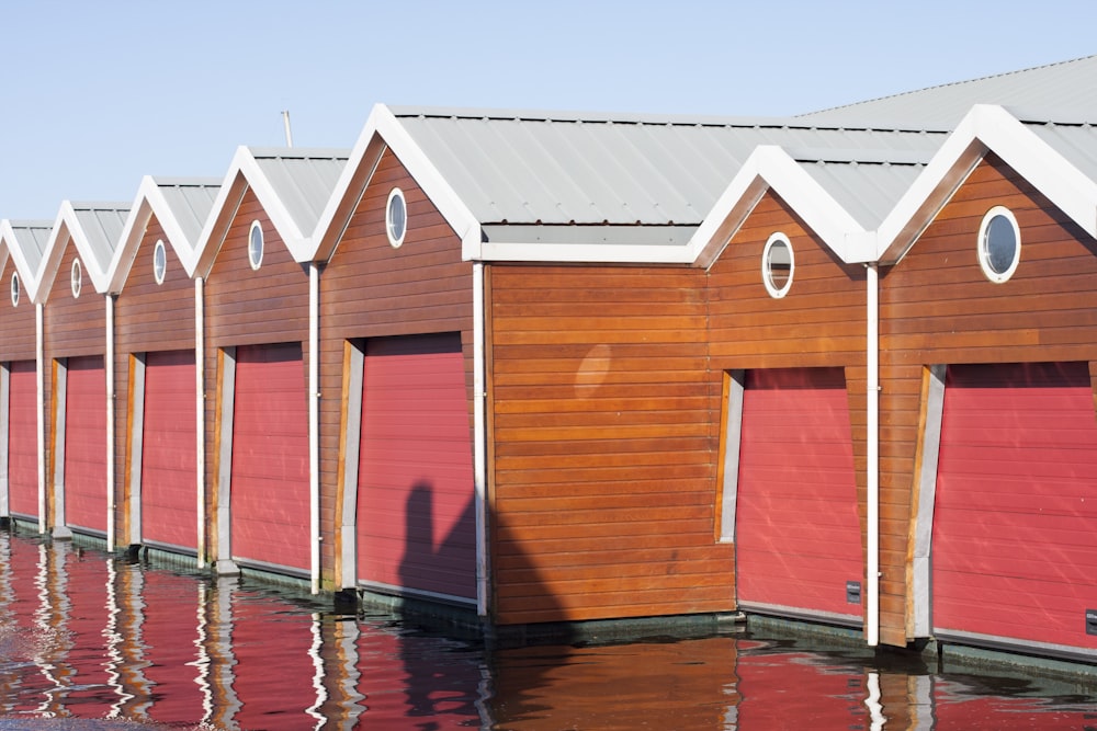 pink-and-brown painted house in front of body of water