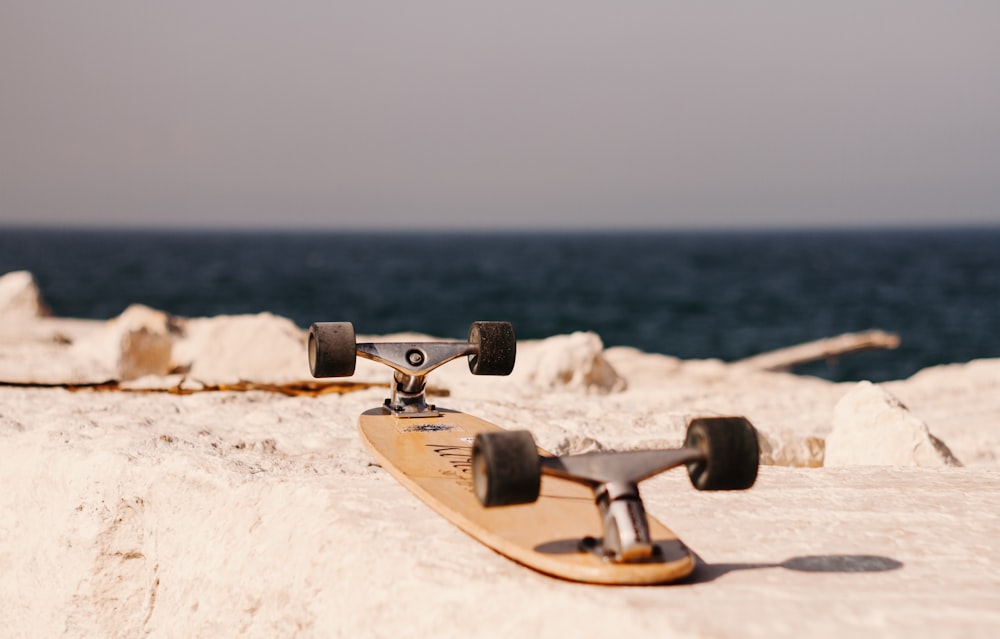 brown skateboard on concrete pavement