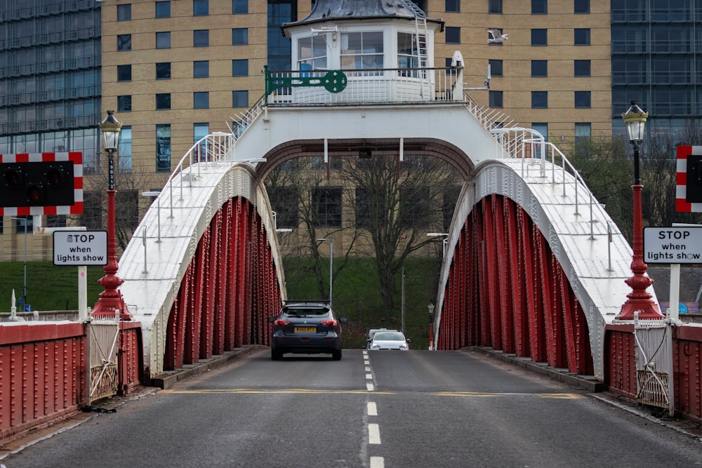 black car crossing bridge