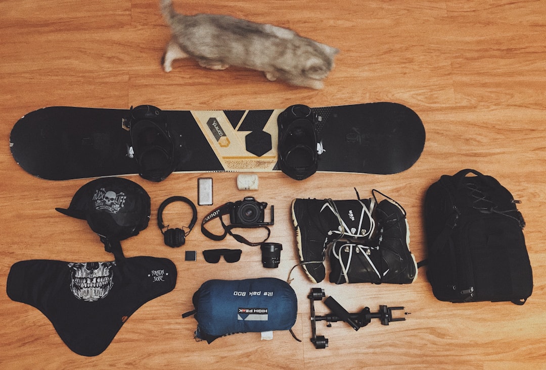 black and brown snowboard with bindings,