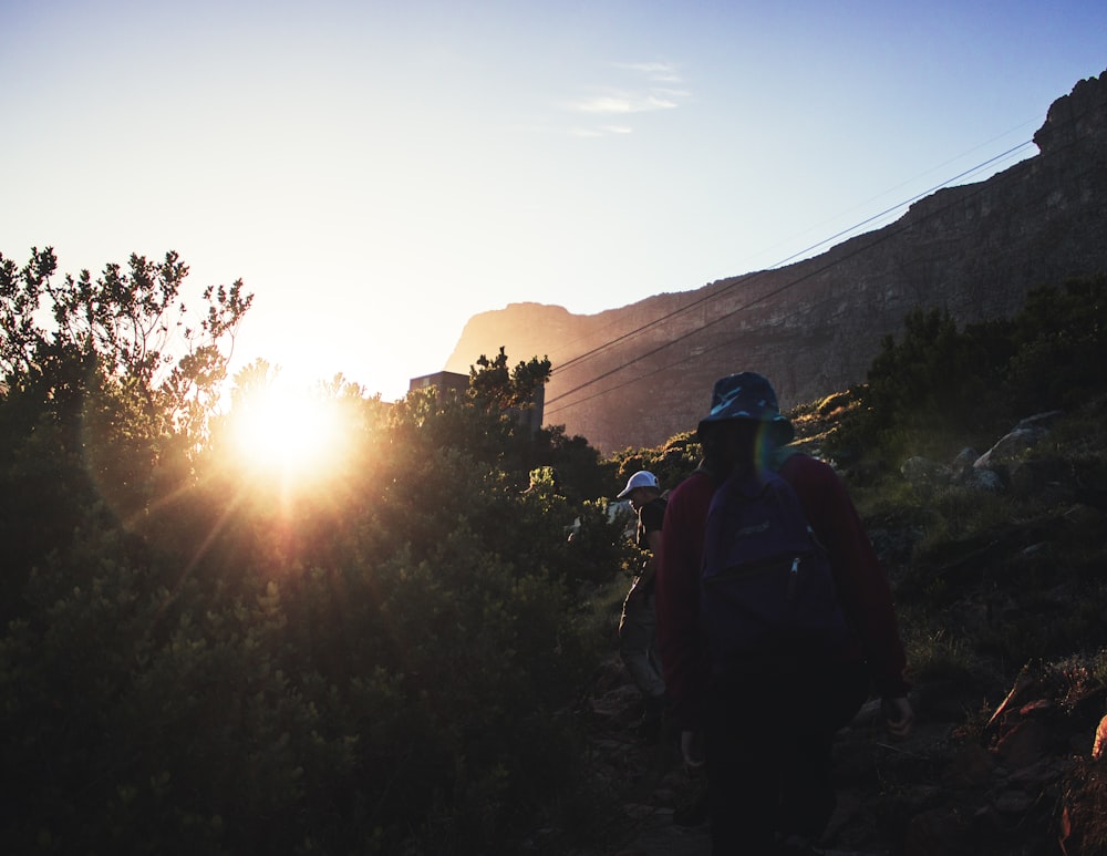 man and woman climbing mountain