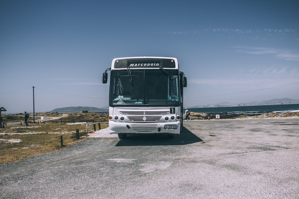 white bus parked outside during daytime